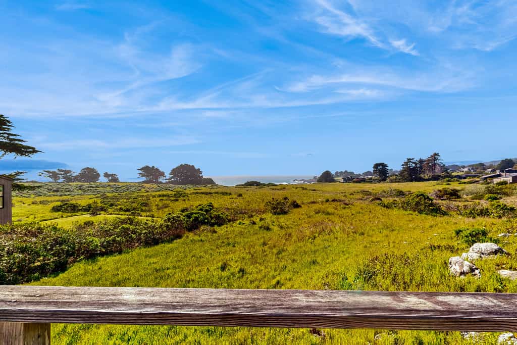 Built on a rock outcropping above the Sea Ranch commons, this three-bedroom home looks straight out at white water near Pebble Beach — and it welcomes two dogs. Inside, wood walls climb to vaulted ceilings, a wood stove takes the edge off foggy evenings, and a handmade quilt waits on every bed. Decks on both sides of the house; sleeps 6. The south rec center pool is a 10-minute walk, the Pebble Beach trail under 15, and Gualala's groceries and galleries are 10 minutes north on Highway 1.