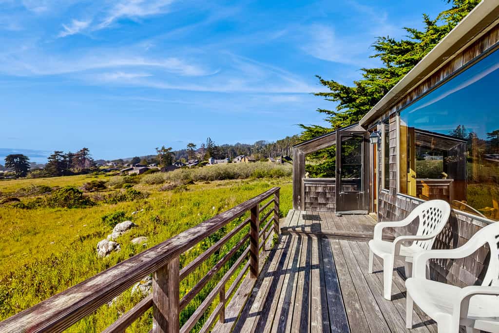 Built on a rock outcropping above the Sea Ranch commons, this three-bedroom home looks straight out at white water near Pebble Beach — and it welcomes two dogs. Inside, wood walls climb to vaulted ceilings, a wood stove takes the edge off foggy evenings, and a handmade quilt waits on every bed. Decks on both sides of the house; sleeps 6. The south rec center pool is a 10-minute walk, the Pebble Beach trail under 15, and Gualala's groceries and galleries are 10 minutes north on Highway 1.