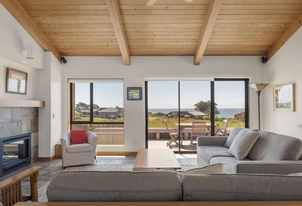 This Sea Ranch home frames the Pacific like a painting -- and the view changes by the hour. Soak in the hot tub as the sun dips below the Pacific. Curl up by the fireplace as fog rolls in off the Pacific. Room for 6 in this 2-bedroom home. Sea Ranch community pools, tennis courts, and the Lodge are nearby. Your front door opens to Sea Ranch's 50 miles of trails and the wild Sonoma Coast. Nothing resets your pace like watching the tide come and go from your own living room.