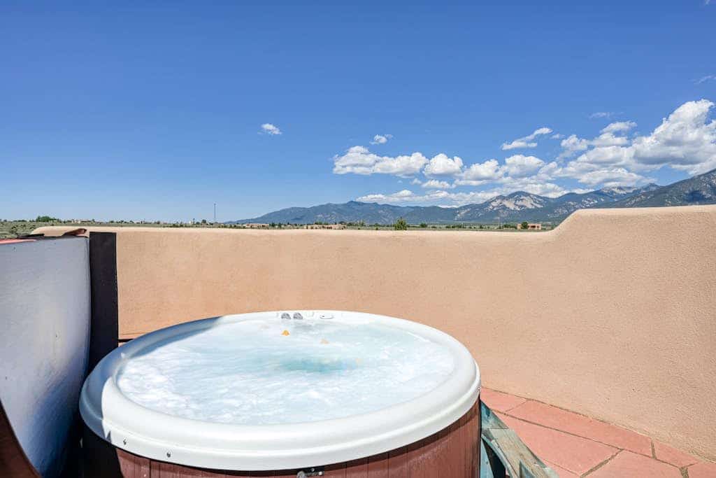 Experience classic New Mexico charm at Taos Mountain House, a peaceful adobe retreat surrounded by sweeping mountain views. With space for up to 12 guests, 4 bedrooms, multiple living areas, and dog-friendly accommodations, this home is designed for families and groups looking to relax, reconnect, and explore Taos and Taos Ski Valley. After a full day outdoors, unwind in the private hot tub, gather around the firepit, or settle in by the wood-burning fireplace for a cozy evening in.