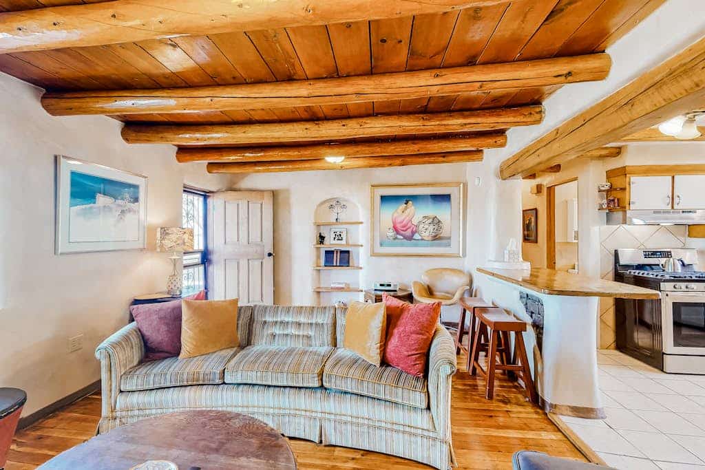 Welcome to Hacienda del Canon, a lovingly restored 1938 territorial-style adobe just under two miles from Taos Plaza. Warm your evenings by the kiva fireplace beneath exposed viga ceilings, cook in a sunny full kitchen, and take in mountain views from the covered porches of this fully enclosed compound. With two queen bedrooms, hardwood floors, and a dog-friendly welcome, it is a charming, light-filled basecamp for exploring Taos.