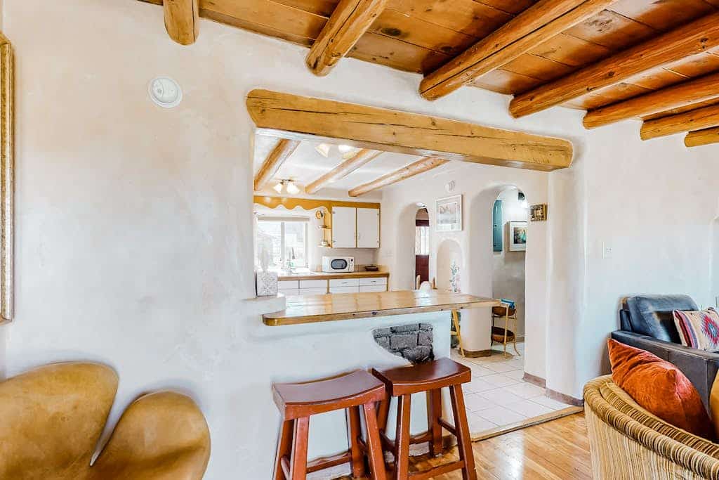 Welcome to Hacienda del Canon, a lovingly restored 1938 territorial-style adobe just under two miles from Taos Plaza. Warm your evenings by the kiva fireplace beneath exposed viga ceilings, cook in a sunny full kitchen, and take in mountain views from the covered porches of this fully enclosed compound. With two queen bedrooms, hardwood floors, and a dog-friendly welcome, it is a charming, light-filled basecamp for exploring Taos.