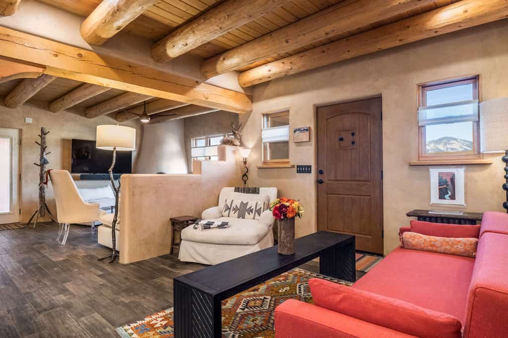Welcome to Hora Feliz, a single-level adobe escape in El Prado, set between Taos and the ski valley with sweeping Sangre de Cristo views. Sip morning coffee beneath viga ceilings, gather in the open kitchen, and challenge the family to ping-pong in the game room. Outside, soak in the private hot tub, grill dinner on the covered patio, and watch the sun set over the mountains from your fully fenced, dog-friendly yard. Your happy hour in the high desert starts here.