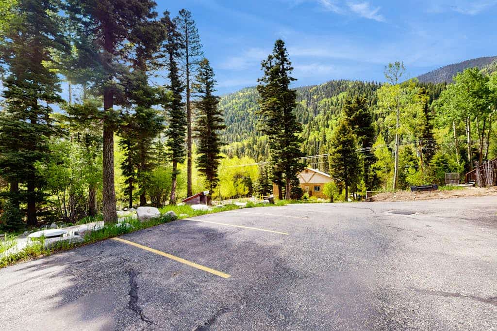 Welcome to Sweet Retreat, your cozy mountain basecamp tucked into the pines of Taos Ski Valley. This updated third-floor condo pairs a warm, light-filled living space with a fireplace, a full kitchen, and forest views from nearly every window. Ski the mountain just up the road, soak in the quiet of the stream across the way, then unwind in the shared fitness room and game room steps from your door. Whether you are here for powder days or a peaceful reset, this is your home away from home.
