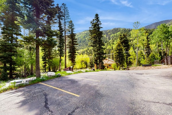 Welcome to Sweet Retreat, your cozy mountain basecamp tucked into the pines of Taos Ski Valley. This updated third-floor condo pairs a warm, light-filled living space with a fireplace, a full kitchen, and forest views from nearly every window. Ski the mountain just up the road, soak in the quiet of the stream across the way, then unwind in the shared fitness room and game room steps from your door. Whether you are here for powder days or a peaceful reset, this is your home away from home.