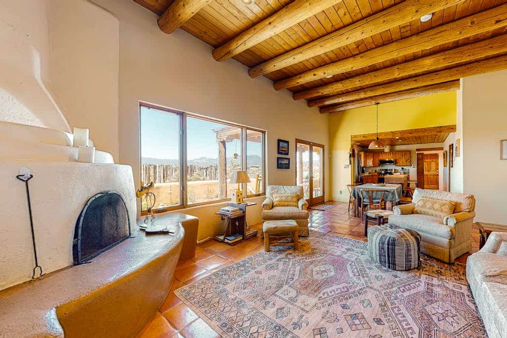 Welcome to Casa Luna, a single-level adobe retreat in Ranchos de Taos with sweeping mountain and valley views. This pueblo-style home wraps authentic Southwest character around a furnished verandah, a gas grill, and a fire pit made for sunset evenings. Cook in the updated kitchen, gather by the wood-burning kiva fireplace, and let everyone spread out in the open high-desert setting. Next to Taos Country Club and minutes from downtown Taos, it is a comfortable, family-friendly base.