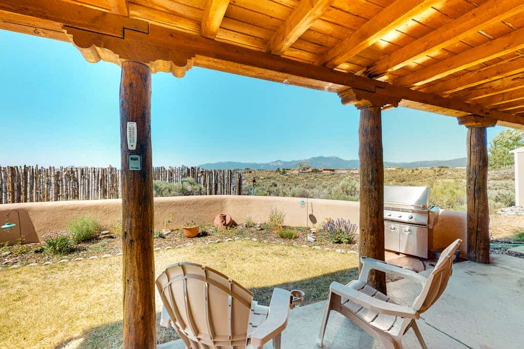 Welcome to Casa Luna, a single-level adobe retreat in Ranchos de Taos with sweeping mountain and valley views. This pueblo-style home wraps authentic Southwest character around a furnished verandah, a gas grill, and a fire pit made for sunset evenings. Cook in the updated kitchen, gather by the wood-burning kiva fireplace, and let everyone spread out in the open high-desert setting. Next to Taos Country Club and minutes from downtown Taos, it is a comfortable, family-friendly base.