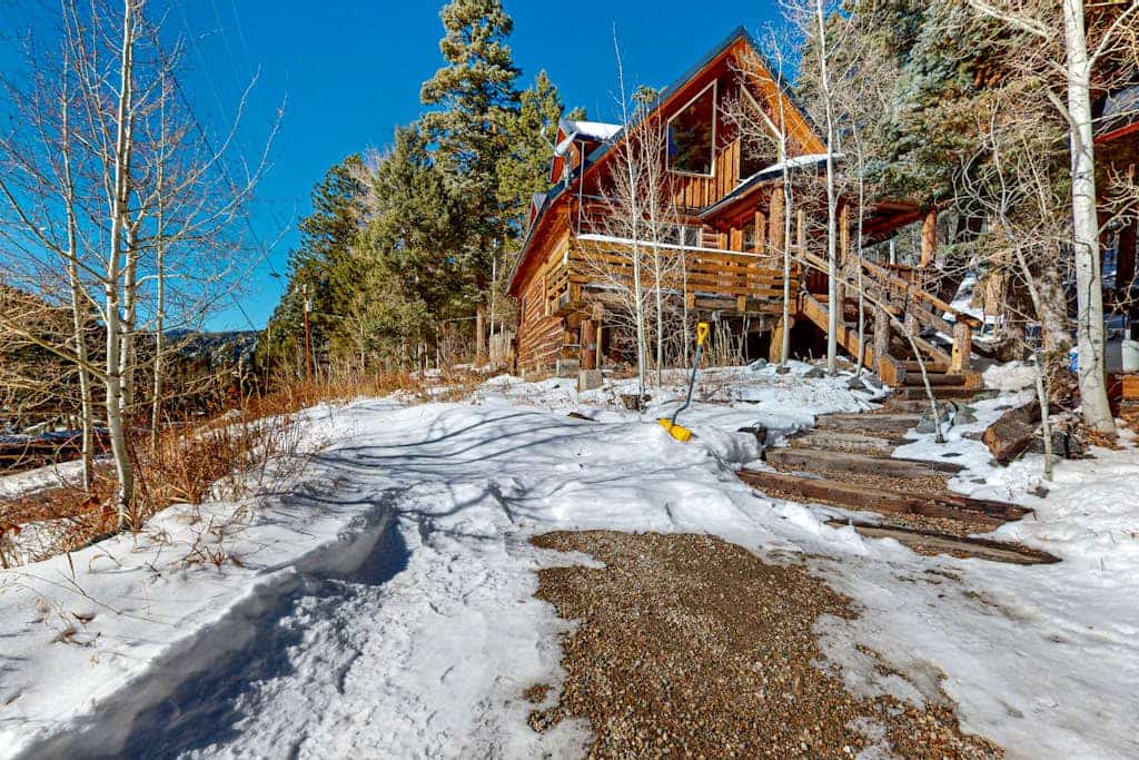 Welcome to Ridgerunner Cabin, a true log cabin tucked into Taos Ski Valley, less than a mile from the resort and surrounded by Carson National Forest and the Rio Hondo. Warm up by the cast iron wood stove and soak in the private hot tub among the pines. With a king bedroom, a spacious loft, and room for up to ten, it is a cozy alpine basecamp for ski trips and summer adventures alike.