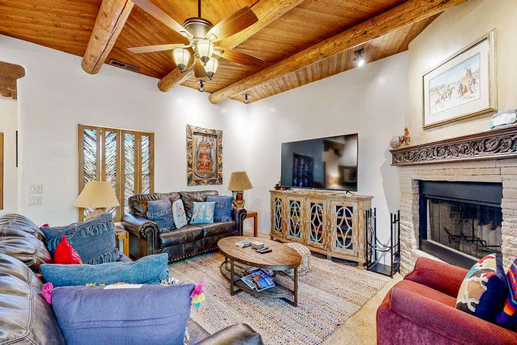 Welcome to Casa Del Norte, a stylish two-level townhome a short walk from Santa Fe's historic Plaza. Inside, classic vigas, two fireplaces, and a chef's kitchen meet easy modern comfort. Step out to a private walled courtyard of flagstone, perfect for morning coffee or an evening glass of wine under the stars. After a day of galleries, green chile, and mountain air, unwind in the primary suite's jetted tub. A garage and driveway parking make downtown Santa Fe feel effortless.