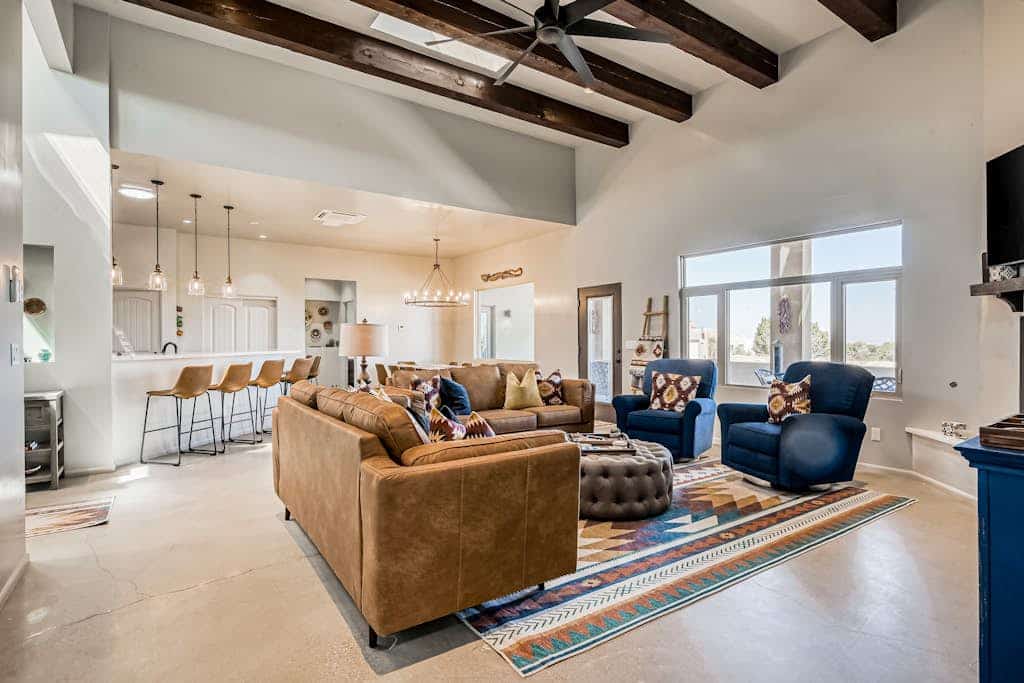 Welcome to Casa Ponderosa, a single-level desert retreat in Eldorado just outside Santa Fe. Soak in the private hot tub under wide-open skies, gather in the light-filled great room by the gas fireplace, and cook for the whole group in the chef's kitchen. With four bedrooms, a playful bunk room, a covered patio with a grill, and room for eight, it is an easy, comfortable home base for exploring the high desert and the City Different.