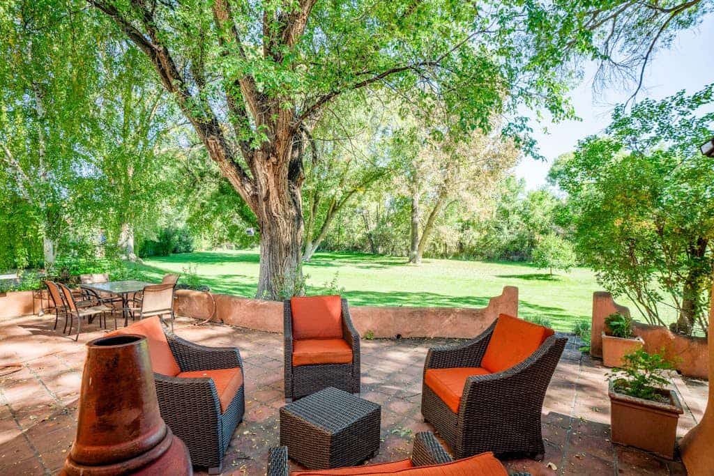 Escape to Casa Rosa, a sun-drenched 1916 adobe estate on more than two acres of historic gardens just minutes from Taos. Wander brick courtyards past a tiled fountain, soak in the private hot tub under the cottonwoods, and gather by the kiva fireplace as evening falls. With five bedrooms, four baths, a vibrant tiled kitchen, and a sunlit library, there is room for everyone to spread out, slow down, and reconnect.