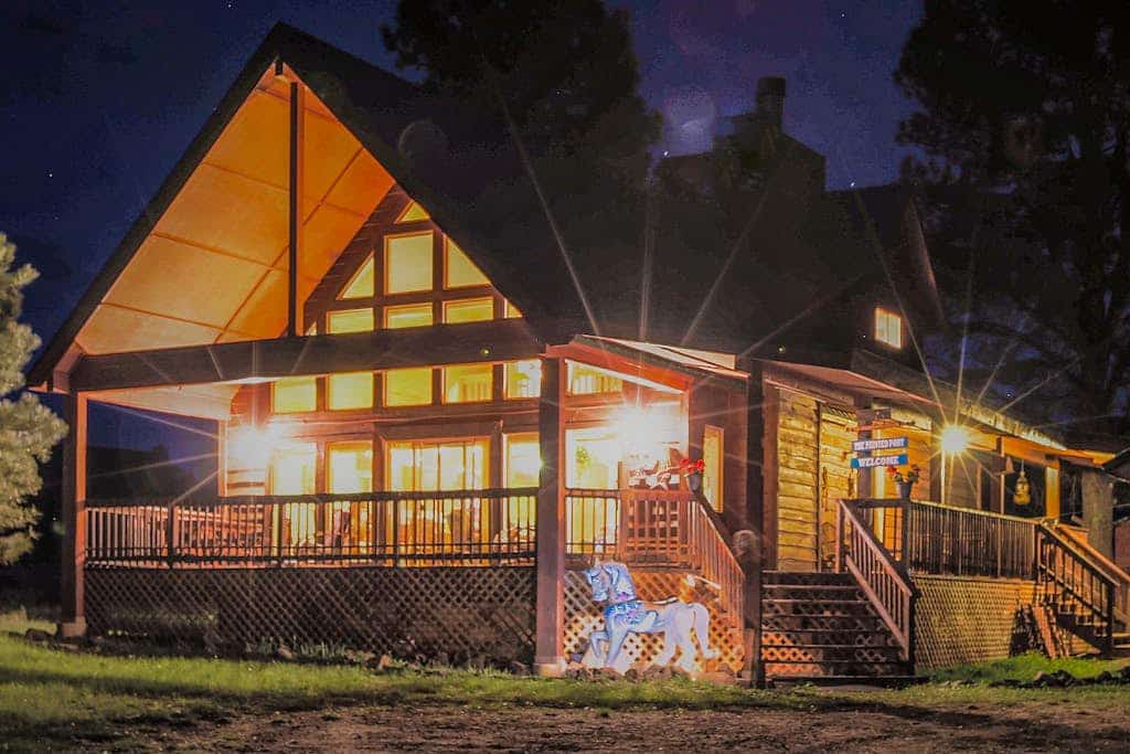 Welcome to Painted Pony Cabin, a charming log retreat tucked among tall pines on a peaceful stretch of Angel Fire. Gather in the soaring great room by the fireplace, cook together in the full kitchen, and spill out onto the wraparound deck to grill, sip coffee, and watch for deer and elk. With three bedrooms, a cozy loft, and the slopes just over a mile away, it is your year-round basecamp for mountain adventure and slow, restful mornings.