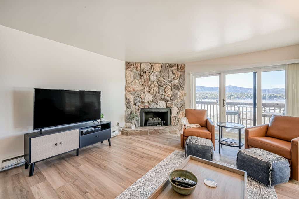 Welcome to Mountain Meadows Views, a bright, updated Angel Fire condo with big mountain, valley, and meadow views right from the private balcony. Sip morning coffee while you watch wildlife in the meadow, cozy up by the fireplace after a day on the slopes, and cook in the full kitchen with a breakfast bar for four. With a king bedroom, a sofa bed, and two full baths, it is a comfortable, single-level base year-round, and you are right on the ski shuttle route.