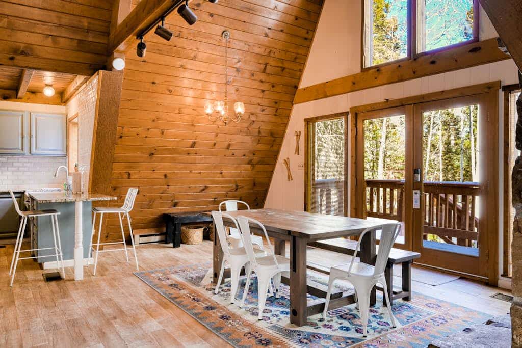 Welcome to your dream A-frame retreat, tucked away in the mountains of Northern New Mexico. Surrounded by towering trees and visiting wildlife, this spacious home is the ultimate base for exploring Angel Fire Resort and beyond. After a day of skiing or hiking, come home to challenge friends to a game of foosball, gather by the stone fireplace, or watch the sunset from the wrap-around balcony. It’s the perfect mountain escape for families and groups looking to reconnect in nature.