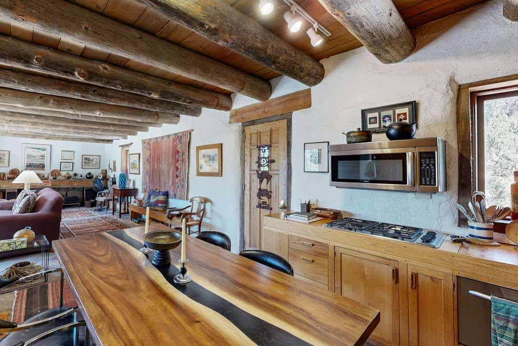 Welcome to Casa de las Piedras, a one-of-a-kind Pueblo-style retreat tucked into the hills outside Santa Fe. Surrounded by high-desert beauty and sweeping mountain and valley views, this rustic 2-bedroom home is filled with regional art, vigas, and Southwestern charm. Watch golden sunsets from the stone terrace, gather for meals in the gazebo, and step out your door onto hiking trails, with downtown Santa Fe just a short drive away.