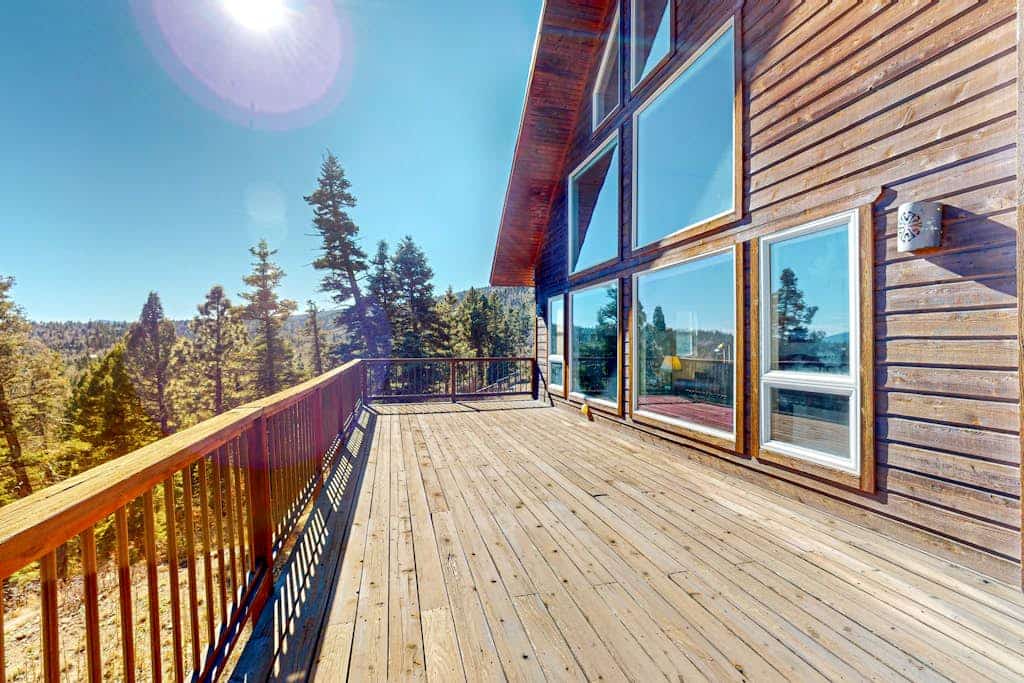 Welcome to Peter's Place, a soaring cabin-style home set among the pines just three miles from Angel Fire Resort. Gather in the vaulted great room around the river-rock gas fireplace, take in panoramic mountain and valley views through walls of windows, and step onto the expansive decks for coffee at sunrise and stars at night. Cook in the granite kitchen, soak in the primary suite's jetted tub, and spread out across three levels with room for ten.