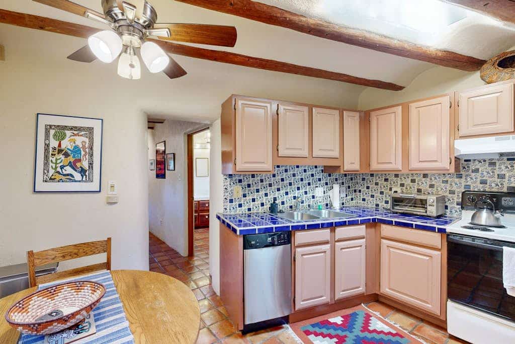 Step into a charming historic adobe casita in the heart of Santa Fe’s desirable Eastside. Casa De Lorena blends authentic Southwestern character with modern comfort, featuring a wood-burning kiva fireplace, traditional vigas ceilings, colorful Mexican tile, and a peaceful private garden patio. With 1 bedroom and space for up to 3 guests, this cozy retreat is perfect for couples, solo travelers, or small groups looking to explore Santa Fe on foot, just minutes from Canyon Road galleries, downtown shops, and the historic Plaza.