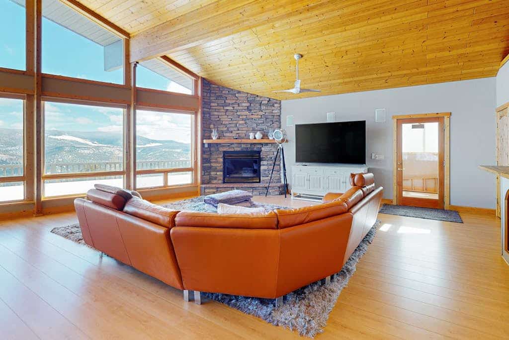 Welcome to Le Chalet Bleu, a striking blue mountain chalet perched high above Angel Fire with panoramic views of the valley, mountains, and distant lake. Sleeping eight across three bedrooms, this spacious 4,700+ sq ft retreat is built for gathering, with a vaulted great room and walls of windows, a full kitchen, an in-home movie theater, and a game room with pool and ping-pong. Soak in the jetted tub, warm up by the gas fireplace, and watch the sky change from the wraparound deck.