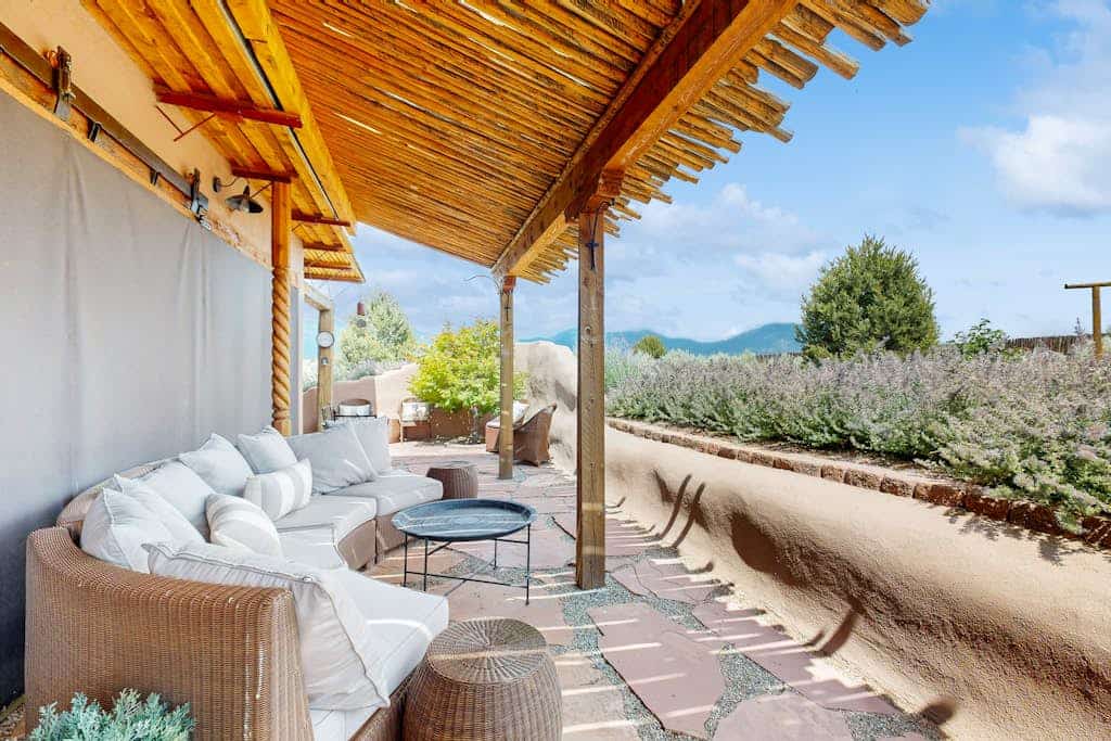 Welcome to Casa de Taos, an artful adobe home on 2.5 private acres of high-desert mesa with sweeping mountain views. Soak in the outdoor hot tub beneath brilliant starry skies, lounge on the wraparound covered porch, and sunbathe in the walled courtyard. Warm up by the wood-burning stove, cook in the chef's kitchen, and feel the comfort of radiant-heated slate floors. Just minutes from Taos and Taos Ski Valley, it is an unforgettable Northern New Mexico escape.