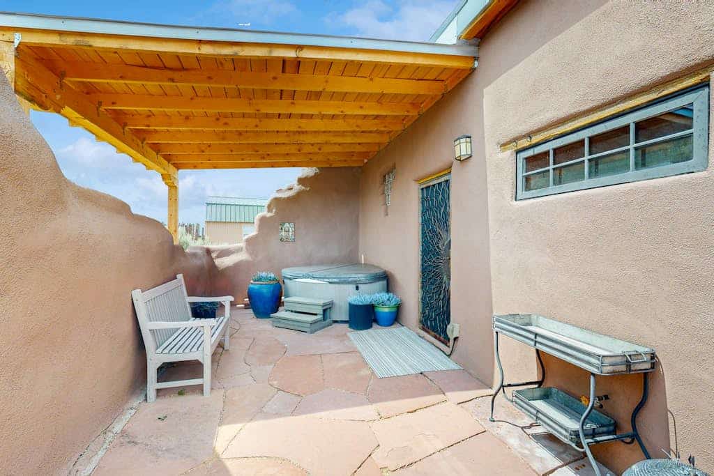 Welcome to Casa de Taos, an artful adobe home on 2.5 private acres of high-desert mesa with sweeping mountain views. Soak in the outdoor hot tub beneath brilliant starry skies, lounge on the wraparound covered porch, and sunbathe in the walled courtyard. Warm up by the wood-burning stove, cook in the chef's kitchen, and feel the comfort of radiant-heated slate floors. Just minutes from Taos and Taos Ski Valley, it is an unforgettable Northern New Mexico escape.