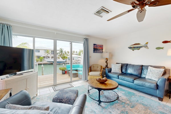 Dog-friendly waterfront home with dock, pool, gas grill, & beach access