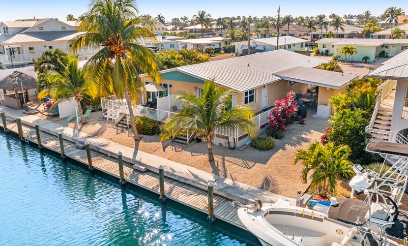 Dog-friendly waterfront home with dock, pool, gas grill, & beach access