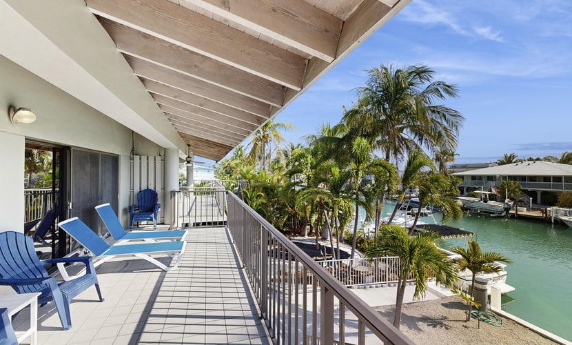 Charming canal-front home with 37-ft dock, kayaks, grill, patio & club access