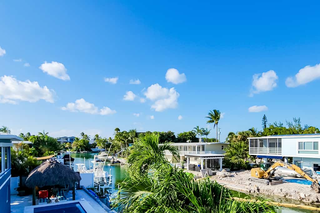 Radiant waterfront retreat with remarkable views, patio, tennis court, & grill