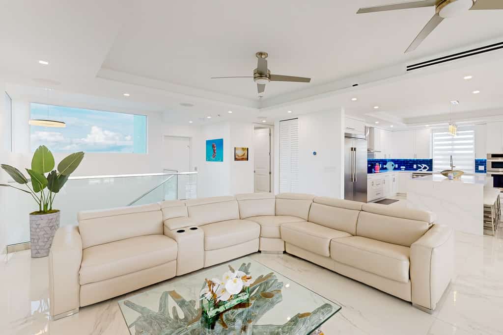 Sprawling waterfront home with pool, outdoor kitchen, game table, grill, & W/D