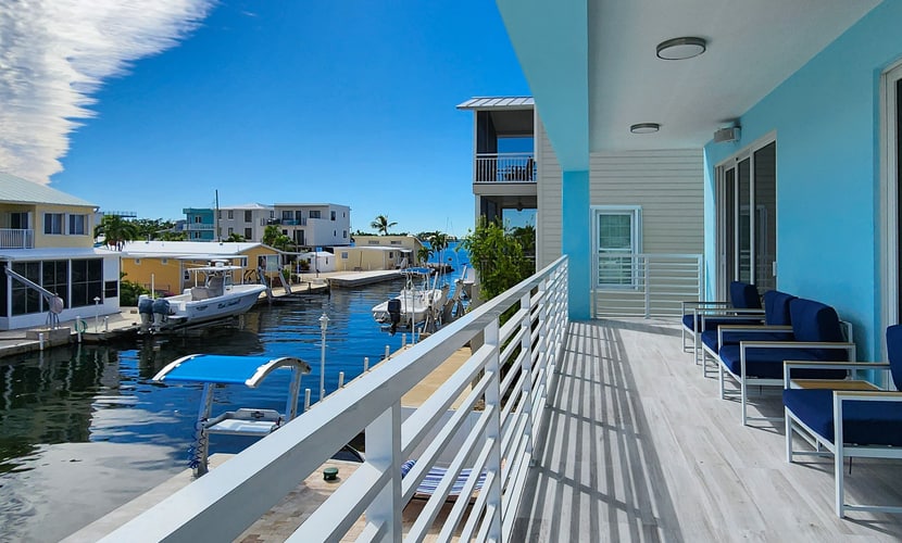 Sprawling waterfront home with pool, outdoor kitchen, game table, grill, & W/D