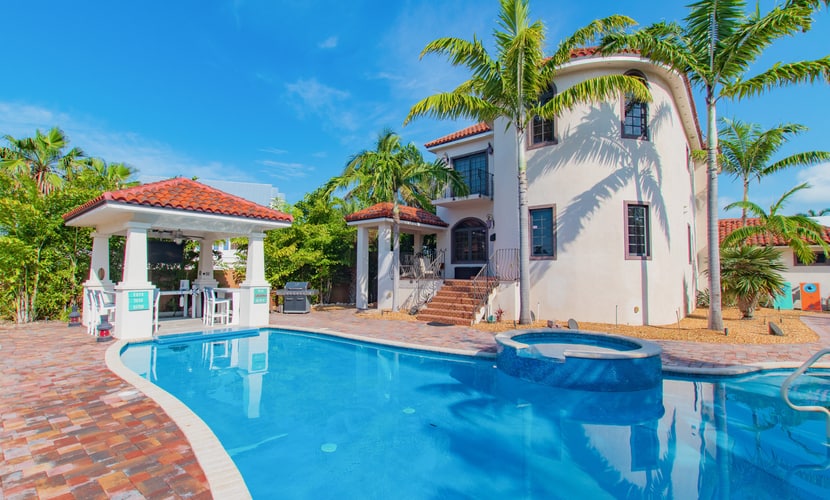 Elegant waterfront home with private pools, hot tub, & dock - walk to beach