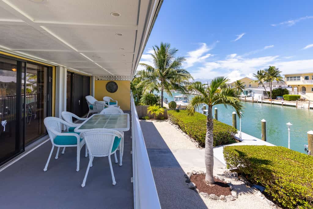 Waterfront home with dock, filet station, patio, balcony, & Cabana Club access