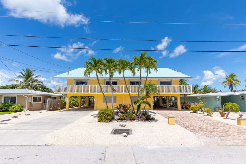 Waterfront home with dock, filet station, patio, balcony, & Cabana Club access