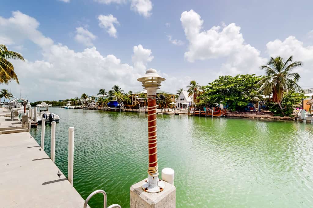 Waterfront home with 60-foot dock & beautiful patio - walk to beach