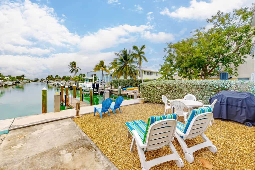 Canal-front duplex with Cabana Club membership, private dock, canal views, grill
