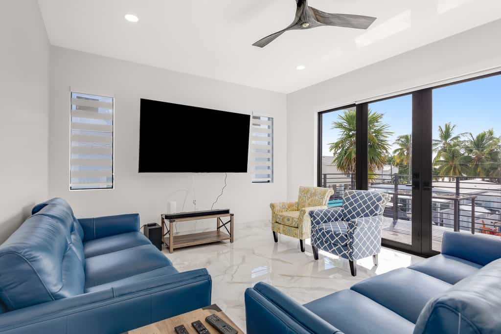 Modern canal-front home with a rooftop deck, open-concept interior, AC, & W/D