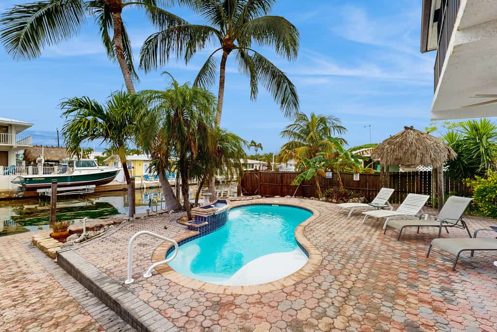 Waterfront house with covered patio, private pool, & 75' dock - dogs welcome
