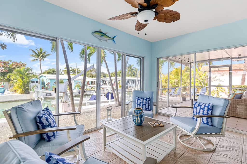 Single-level waterfront home with furnished Florida room, dock, washer/dryer