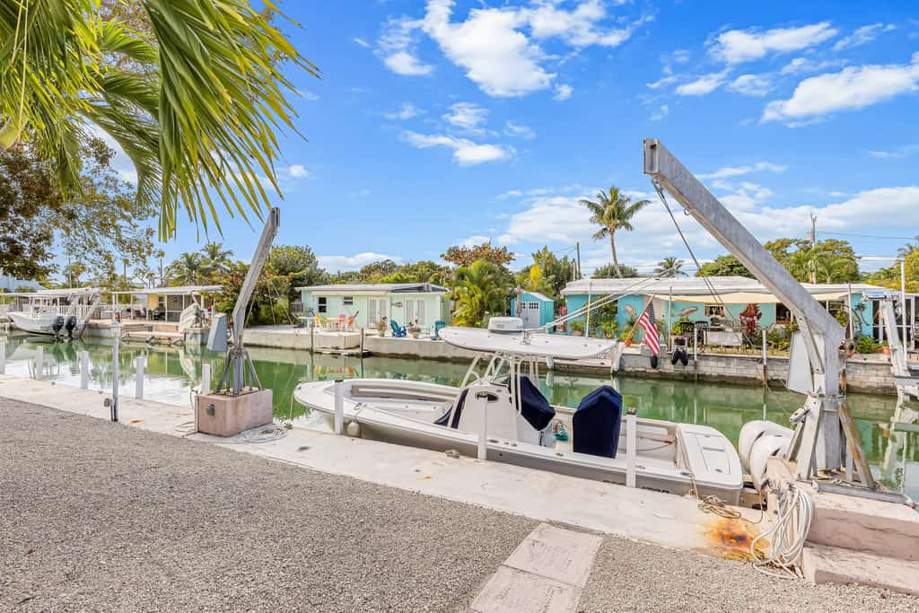 Single-level waterfront home with furnished Florida room, dock, washer/dryer