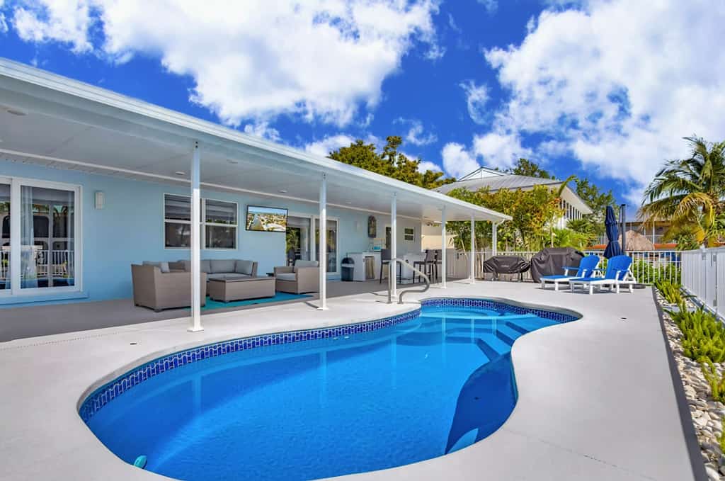 Waterfront home with private heated pool, dock, canal views, grill, AC