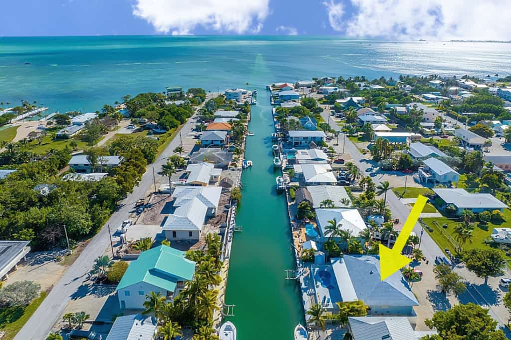Waterfront home with private heated pool, dock, canal views, grill, AC