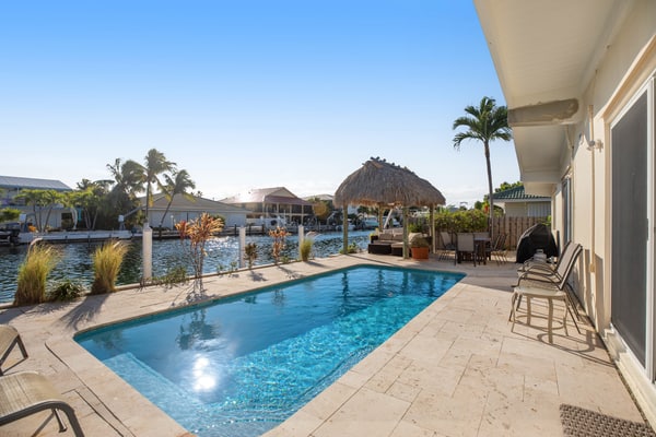 Deluxe canal-front home with pool, water-view patio, grill, & Cabana Club access