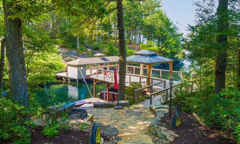 Lakefront home with granite counters, fireplace, lake views, & dock