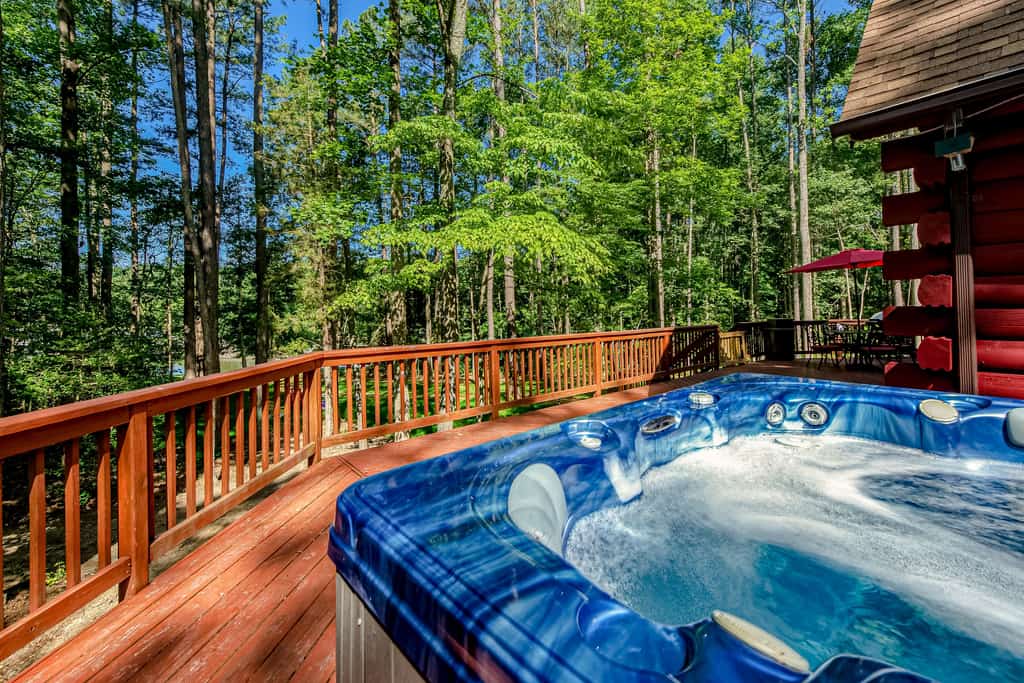 Lakefront home with boat mooring, deck, hot tub, game room & fast WiFi - dogs OK
