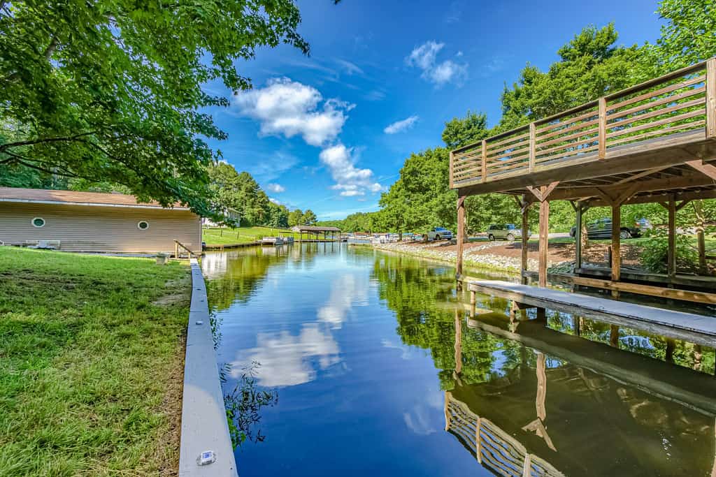 Lakefront home with boat mooring, deck, hot tub, game room & fast WiFi - dogs OK