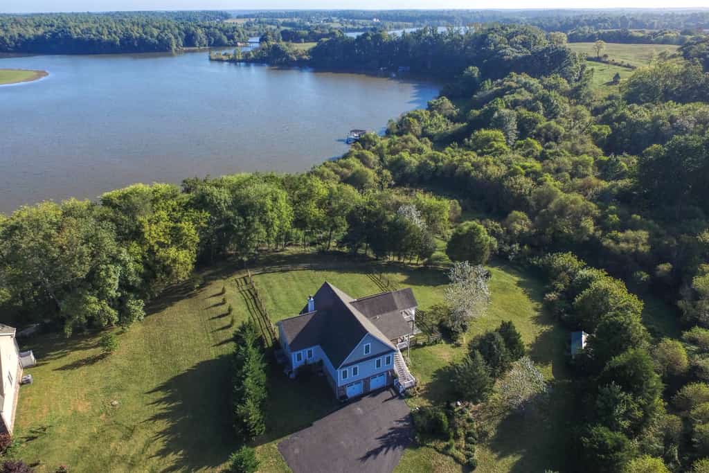 Nature lover's lakefront home with a beach, dock, fire ring, & more