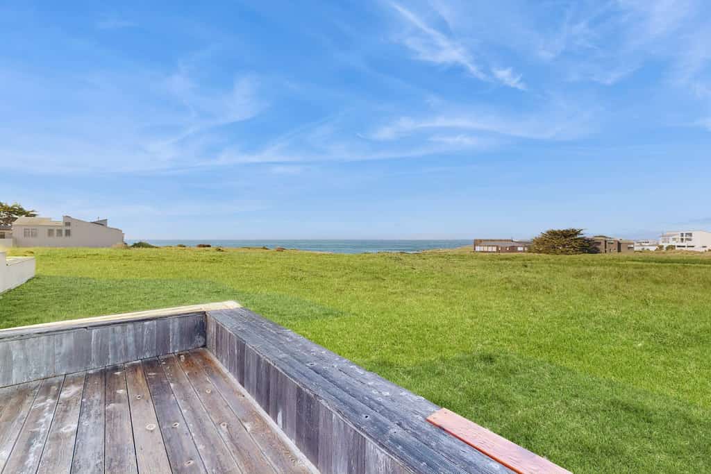 Unobstructed ocean views across a green coastal meadow -- the Pacific stretches to the horizon from your deck. Settle in by the floor-to-ceiling stone fireplace and watch the light change all day. Bring your pup -- dogs love the bluff trails here. Room for 4 in this 2-bedroom home. Sea Ranch community pools, tennis courts, and the Lodge are nearby. A private fenced courtyard with a gas grill makes sunset dinners easy. The ever-changing coastal light fills this home from morning fog to golden evening.