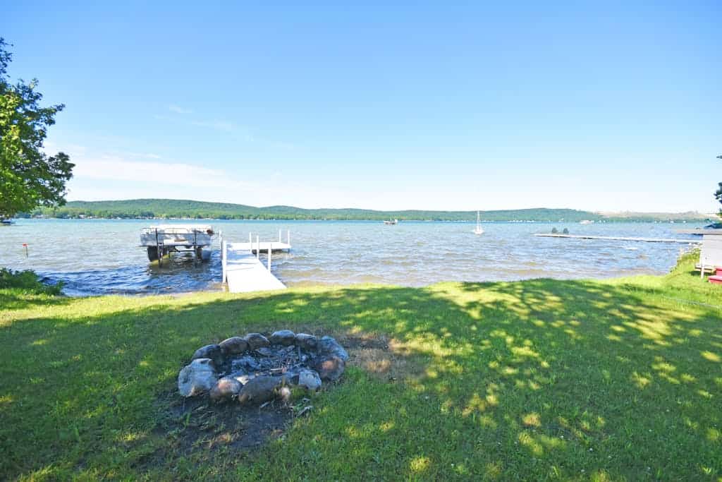 Lakefront home on Little Glen Lake with fireplace, deck, gas grill, and firepit