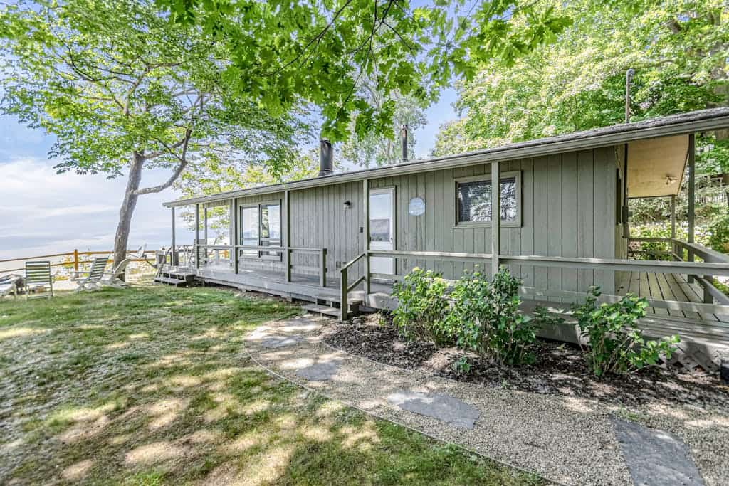 Quaint lakefront cottage w/ private hot tub, firepit, & beautiful sunset views