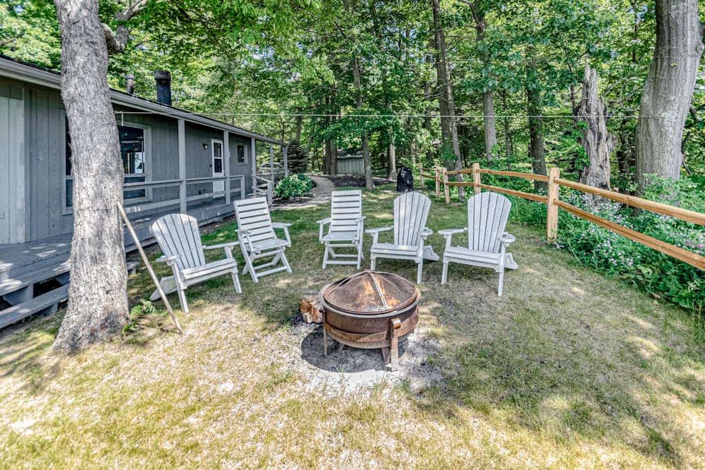 Quaint lakefront cottage w/ private hot tub, firepit, & beautiful sunset views